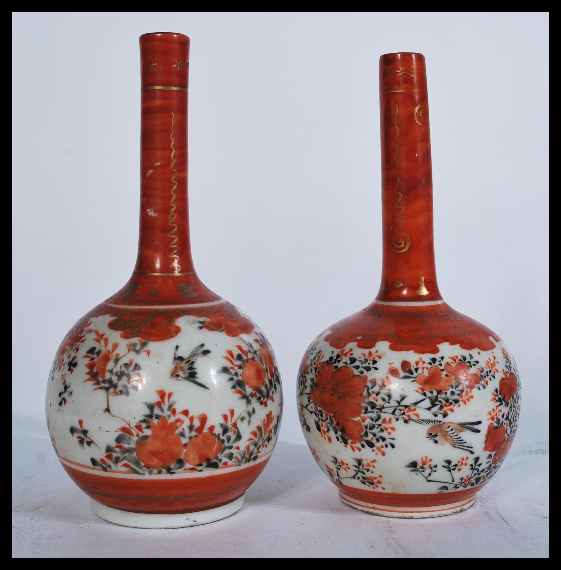 A pair of 19th century Japanese Satsuma vases of baluster form having bulbous globular decoration