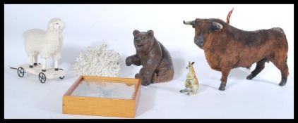 A vintage Black forest style carved bear along with a pull along sheep , cased taxidermy beetle ,