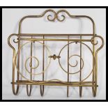 A 19th century Victorian brass wall mounted letter rack / magazine Canterbury of scrolled tubualr