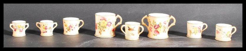 A group of eight Royal Worcester ivory blush miniature tankards and cups. All hand painted with