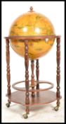 An antique style cocktail drinks globe having with applied terrestrial design with flip top lid