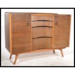 A 1970's beehive front oak veneer sideboard cabinet by Avalon of Yatton. Raised on tapered