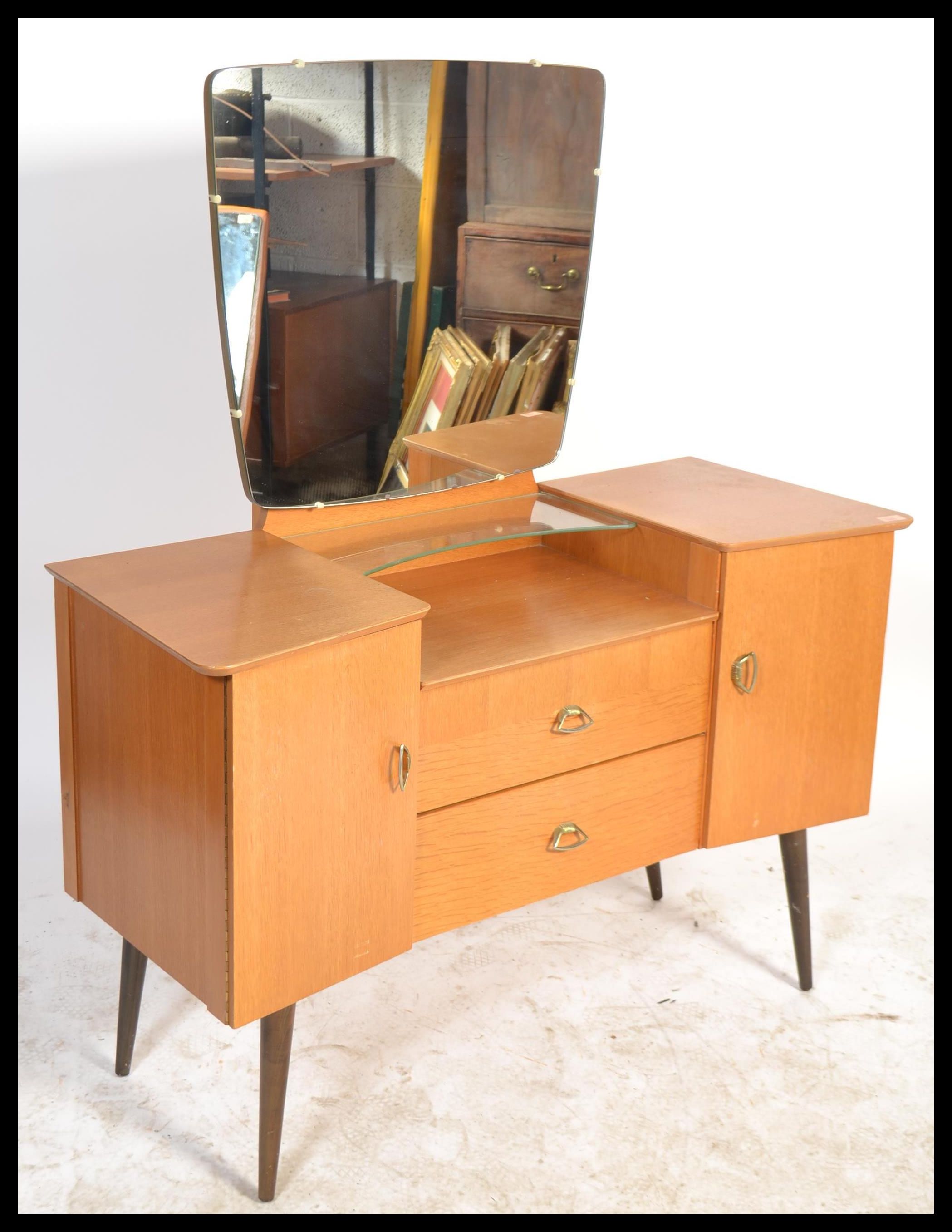 A 1960's retro oak drop centre dressing table being raised on tapering legs with a large mirror of - Image 2 of 6