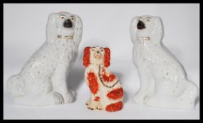 A pair of large Staffordshire 19th Century fireside dogs modelled as a pair of Spaniels together