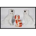 A pair of large Staffordshire 19th Century fireside dogs modelled as a pair of Spaniels together