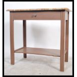 A 20th century French oak and marble console table. The vanilla and rouge veined marble top over