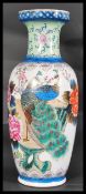 A 20th century Chinese famille rose floor vase / stick stand decorated with colourful scenes and