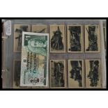 An album containing a collection of vintage cigarette cards dating from the early 20th century to