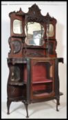 An Edwardian ebonised mirror back chiffonier sideboard having shaped end shelves with central