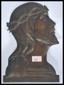 An early 20th century bronze ecclesiastical wall plaque of Jesus Christ. Profile facing right with
