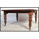 A 19th Century Victorian mahogany large square wind out dining table, raised on fluted and turned