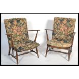 A pair of 1970's beech and elm Windsor pattern armchairs of low form with chintz pad cushions and