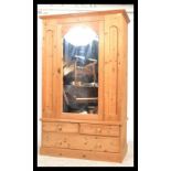 A good quality 20th century antique style pine wardrobe. Plint base with drawers having upright robe