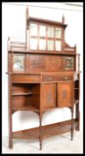 An Edwardian mahogany mirror back chiffonier sidenboard. Raised on turned legs with open shelved and