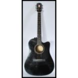 A 20th Century electro - acoustic six string ebonised  guitar by Fender applied paper label to