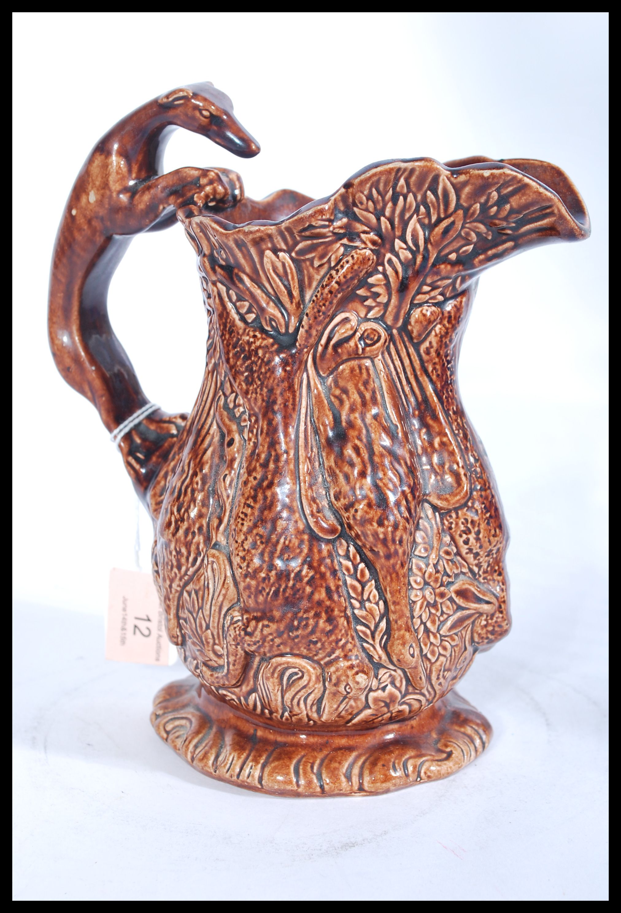 A 19th century Victorian relief jug depicting game featuring various animals with the handle in - Image 2 of 4