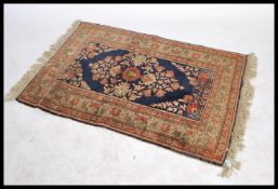 A vintage early 20th century floor rug decorated w