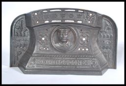 A 19th century Victorian cast iron fire guard Tidy Betty with pictorial Livingstone relief plaque to