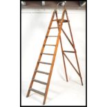 A 20th century large vintage wooden step ladder. Measures: 250xm high x 58cm wide.