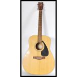 A 20th Century six string acoustic guitar by Yamaha, applied paper label reading Yamaha F310