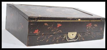 An early 20th century Japanese lacquered writing slope having chinoiserie decoration with birds of