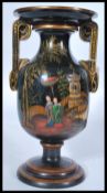 An early 20th century Chinese / Chinoserie black lacquered vase raised on a stepped circular base
