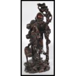 A 19th century Chinese carved hardwood figure of Shouxing, the God of Longevity, holding his staff