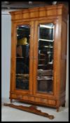 An early 20th century French armoire double wardrobe having stunning twin mirror doors raised on a