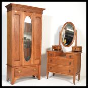 An early 20th Century Edwardian oak single wardrobe, single mirrored door over single deep drawer