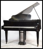 A good Monington & Weston baby grand / boudoir piano in a stunning ebonised mahogany case being
