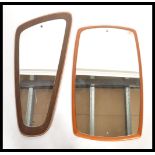 Two vintage retro 20th century teak frameless mirrors one of oblong form and the other