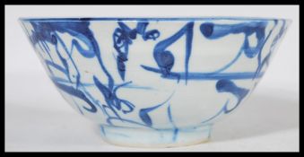 A 19th century Chinese pottery bowl raised on a small circular foot with hand painted decoration