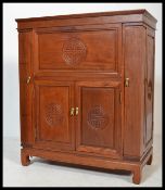 A 20th century Chinese hardwood oriental cupboard with articulated hinged top having mirror lined