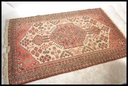 A good 20th Century Persian / Islamic floor rug / carpet with central medallion within a larger