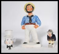 A group of 19th century Stafforsdhire ceramics to include a figurine of Roger Giles' modeled on