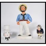 A group of 19th century Stafforsdhire ceramics to include a figurine of Roger Giles' modeled on