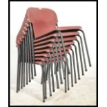 A set of 8 mid century / 1970's stacking chairs with composite red seats set over grey tubular metal