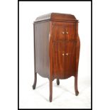 An early 20th Century mahogany cased floor standing HMV Gramaphone raised on cabriole legs,