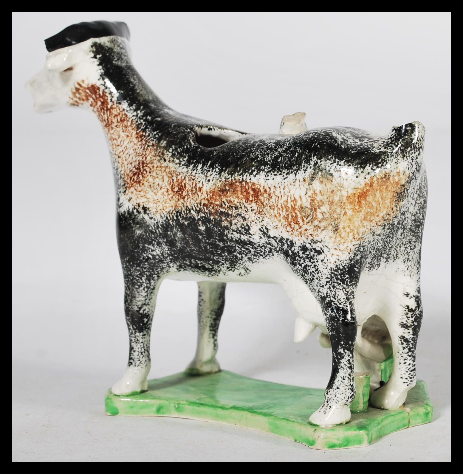 An early C19th Staffordshire pearlware cow creamer, shaped base with milk maid milking into a - Image 2 of 5