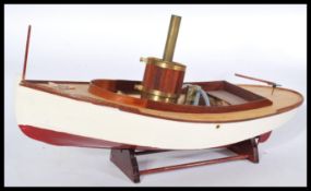 A vintage early 20th century scratch built model of a steam boat with copper and brass burner and