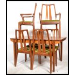 A retro 20th Century teak wood dining suite by Nathan, consisting of four dining chairs raised on