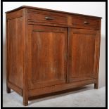 An early 20th Century rustic French Elm Buffet sideboard having two drawers over two panel doors and