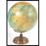 A vintage mid century Philips desk top terrestrial globe raised on a circular wooden base. Makers