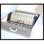 A vintage 20th century 1930s Hohner Carmen 2 piano accordion musical instrument in original case.