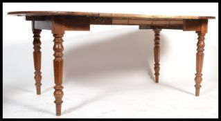A 19th century French fruitwood extending dining t
