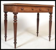 A Victorian mahogany writing table desk being raised on tapering legs with fitted frieze drawers