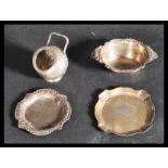 A group of silver items to include a continental silver table salt of mortar form with relief
