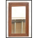 A 20th century oak framed mirror of rectangular form. Cushion shaped scalloped oak mirror frame with