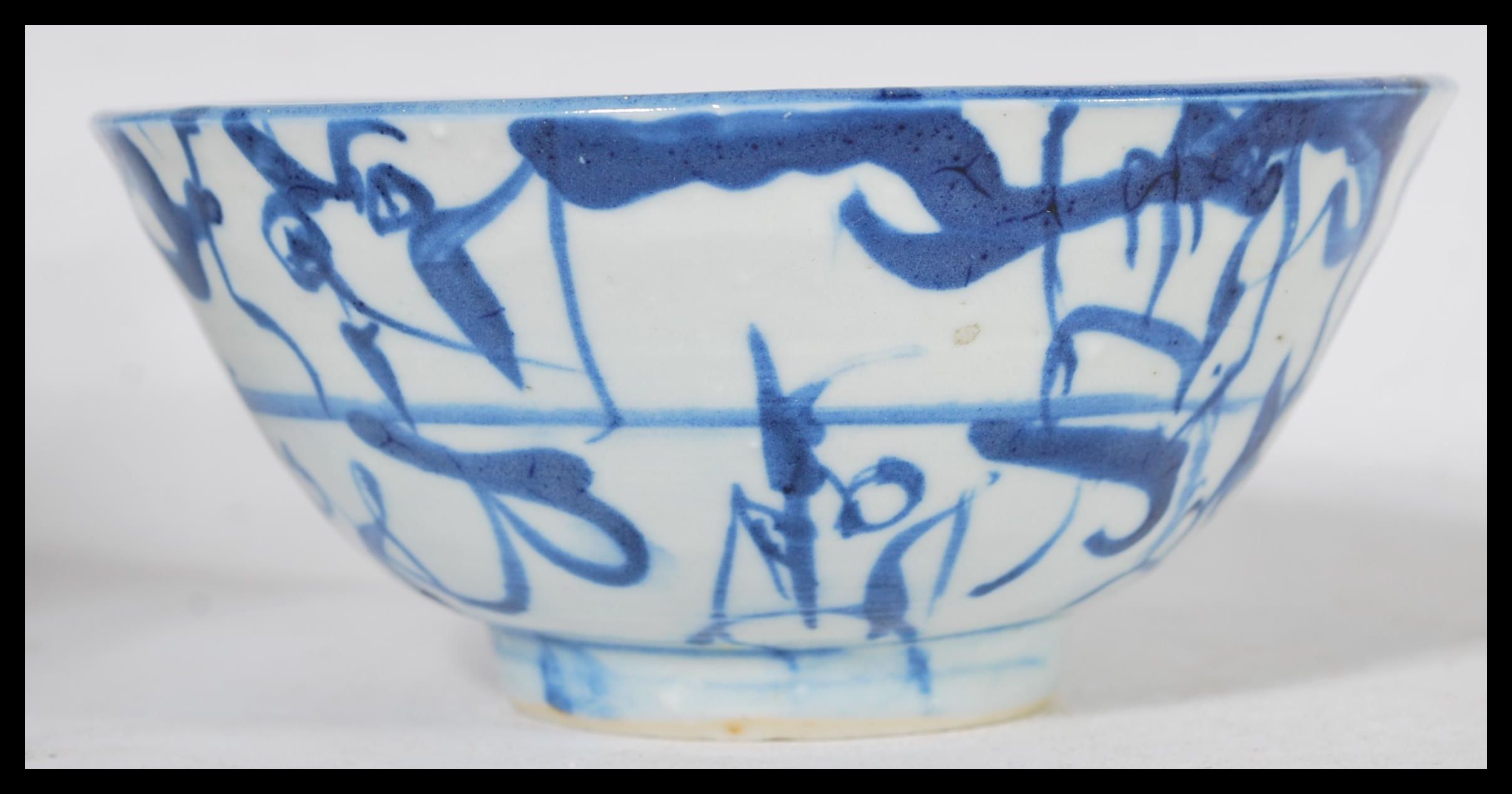 A 19th century Chinese pottery bowl raised on a small circular foot with hand painted decoration - Image 4 of 6