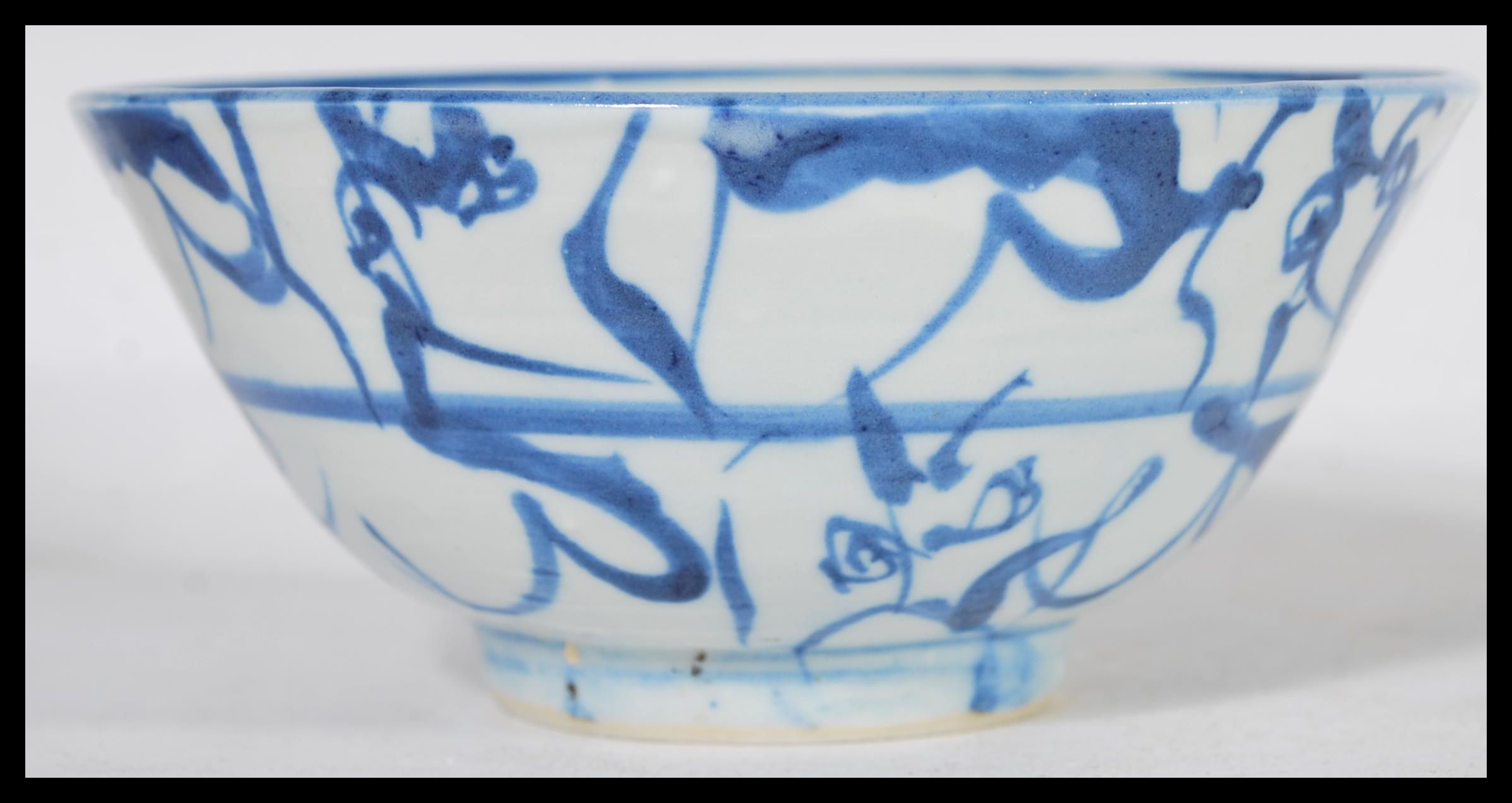 A 19th century Chinese pottery bowl raised on a small circular foot with hand painted decoration - Image 3 of 6